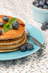 Delicious golden pancakes with fresh blackberries.