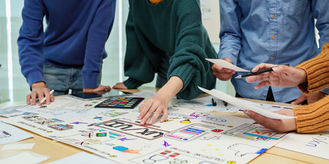 Fototapeta premium Close up ux developer and ui designer brainstorming interface wireframe design.Creative digital development agency