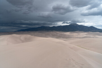 Fototapeta na wymiar Epic mountain and sand dunes with a storm approaching
