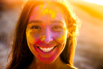 Portrait of a beautiful girl full of colored powder all over the body