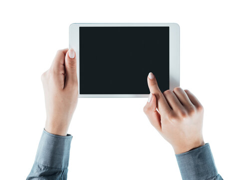 Woman holding a digital tablet on white background, hands close up, unrecognizable person