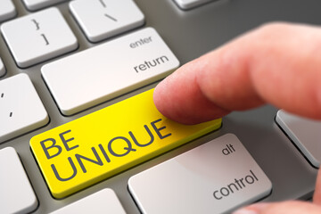 Finger Pushing Be Unique Yellow Button on Laptop Keyboard. 3D Illustration.