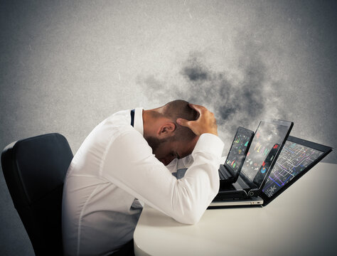 Businessman with worried expression with computers in smoke