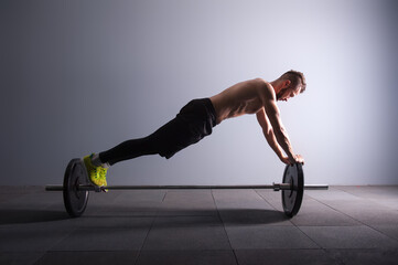 Fototapeta na wymiar one man exercising fitness plank position exercises in studio silhouette isolated dark key