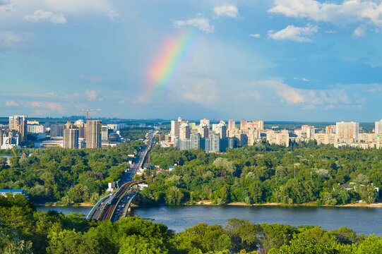 Skyline of Kiev with Metro bridge and rainbow in the sky. Ukraine