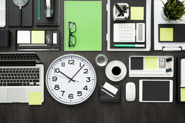 Corporate business desktop with laptop, office accessories and a clock: business productivity and deadlines concept