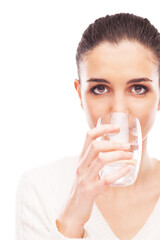 Young woman drinking a glass of fresh water, body hydration concept