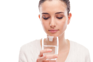 Young woman drinking a glass of fresh water, body hydration concept