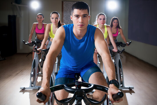 Young man on bicycle indoors