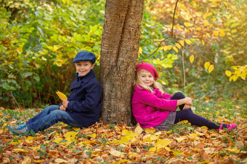 Happy Kids having fun in beauty Autumn Park