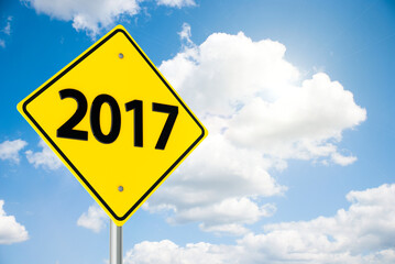 Three-dimensional rendering of road sign 2017 on the blue sky represents the new year 2017, 3D illustration