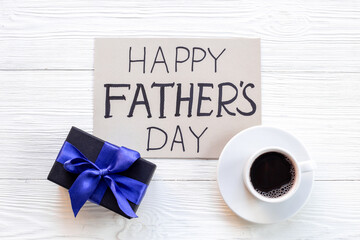 Gift box with blue ribbon for Happy Fathers day. Greeting card concept