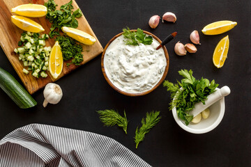Bowl of dip sauce sour cream with herbs and garlic. Homemade dairy product background