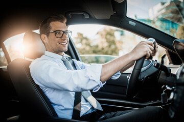 Young businessman driving a luxury car