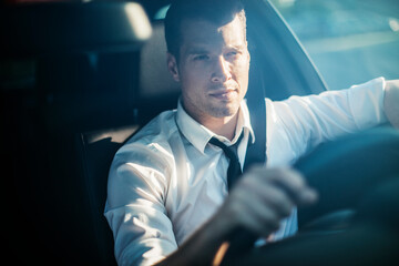 Young businessman driving a luxury car