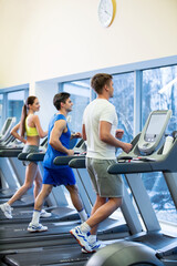 Fototapeta na wymiar Active people on a treadmill