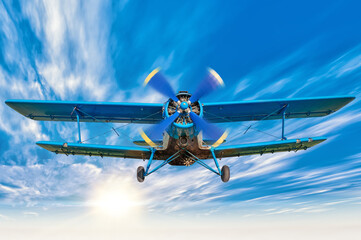 picture of a biplane in the blue sky - obrazy, fototapety, plakaty