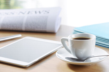 Business Office scene, digital tablet and newspaper with coffee