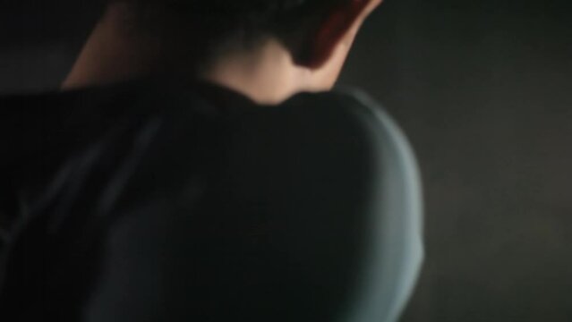 CLOSE-UP SHOT OF A YOUNG CRIMINAL NERVOUS AND TENSED WALKING IN DEFENCE MODE STEALTH MODE WITH A GUN IN HIS HAND. HD FOOTAGE.
