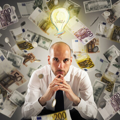 Man with light bulb over his head and money background