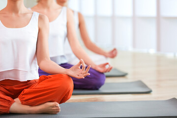 Barefoot women practicing yoga