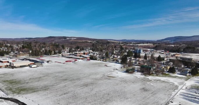 Sunny mid afternoon winter aerial video of Tully, NY, USA.