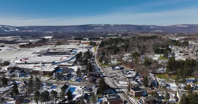Sunny mid afternoon winter aerial video of Tully, NY, USA.