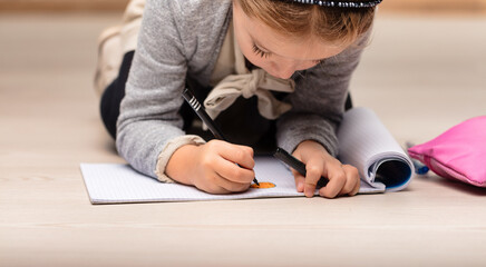 Girl engrossed in drawing, learning through creativity