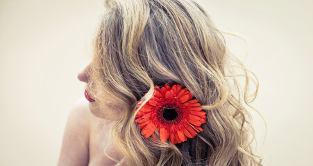 Beautiful girl with a nice flower on the hair