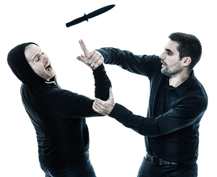 two caucasian men krav maga fighters fighting isolated silhouette on white background