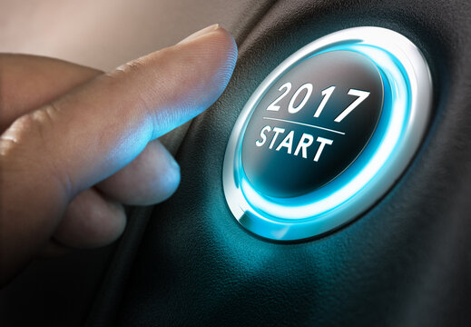 Hand about to press a 2017 button. Concept of new year, two thousand seventeen. Composite between a photography and a 3D background. Horizontal image