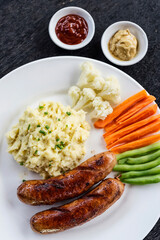 german sausage with mashed potato and vegetables simple meal