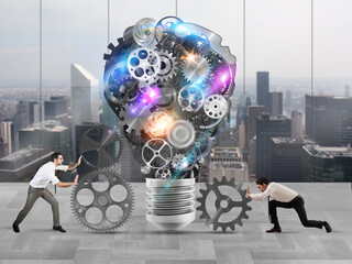 Business team push gears towards a great light bulb. build an idea concept
