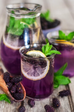 Homemade refreshing mulberry lemonade with lemon and mint