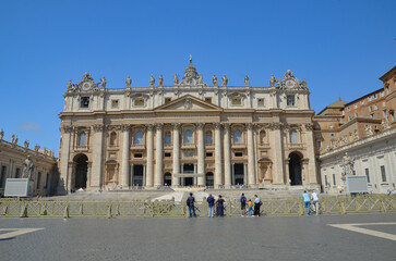 Fototapeta na wymiar View of Saint Peter's Basilica exterior facade with sculptures, obelisk and dome.