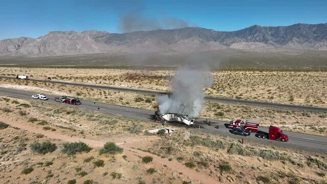 Aerial semi truck desert highway fire smoke burning trucks slide. Interstate highway in desert of Arizona and Nevada. Transporting fresh meat. Fire and smoke destroys cargo and HAZMAT pollution.