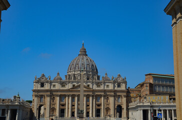 Fototapeta na wymiar View of Saint Peter's Basilica exterior facade with sculptures, obelisk and dome.