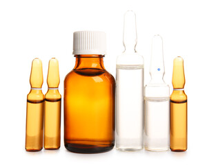 Ampules and bottle with medicines on white background