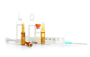 Ampules with syringe on white background