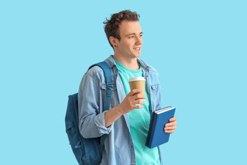 Male student with backpack, books and cup of coffee on blue background