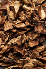 Close-up of dried porcini mushroom slices on moving platform