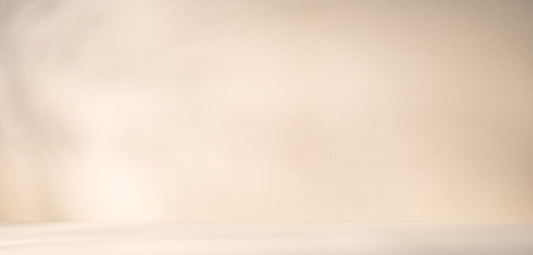 A light beige product presentation background with sunlight beams and shadows on it