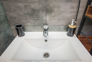 Fototapeta premium White metal sink, liquid soap dispenser, mixer tap