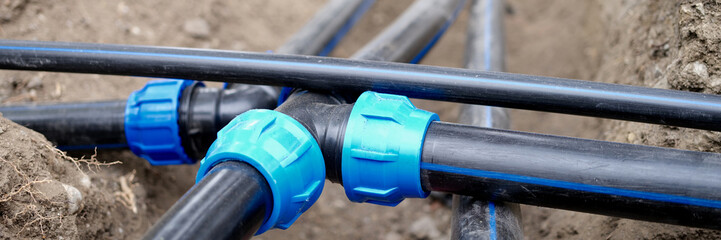 Polyethylene water pipes at construction site.