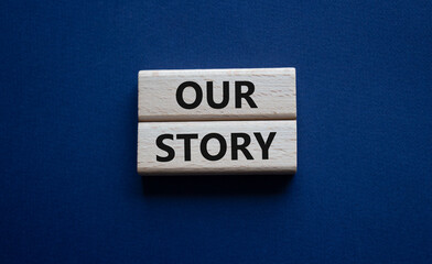 Our story symbol. Wooden blocks with words Our story Beautiful deep blue background. Business and Our story concept. Copy space.