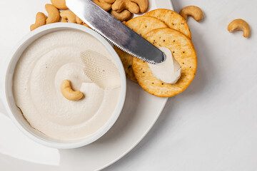 Cashew cream cheese with nuts and crackers, vegan dairy alternative
