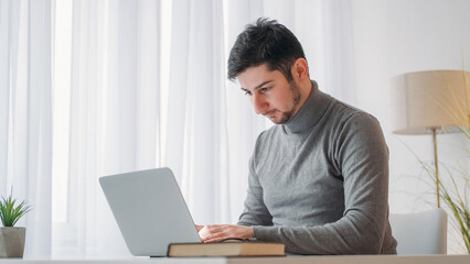 Office job. Laptop research. Programming developer. Serious busy business man hardworking digital marketing employee at computer at desktop at workplace.