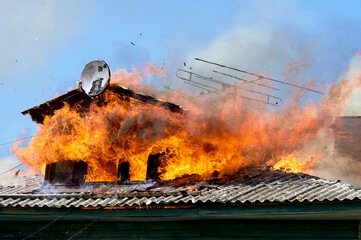 fire on the roof of a wooden house