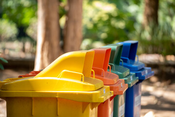 Trash cans for sorting garbage recycle bin waste plastic container collection. Reuse, reduce, recycle sorting process sustainable lifestyle rubbish dustbin plastic box in green garden.