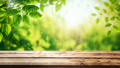 Spring summer beautiful natural background with green foliage in sunlight and empty wooden table...